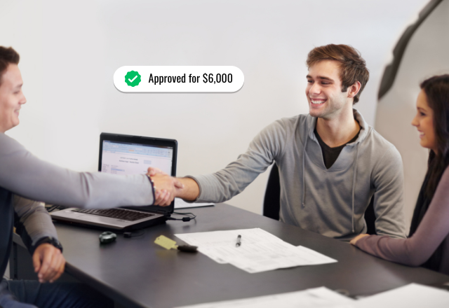 An American couple shaking hands with a tax preparer in his office